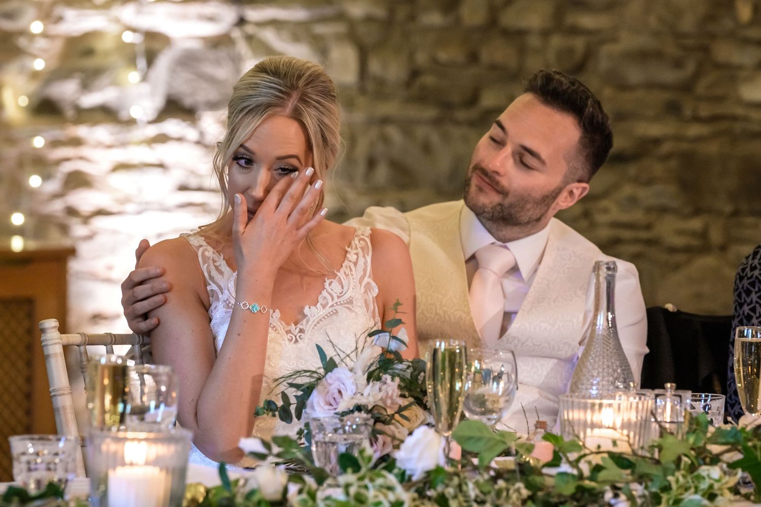 Groom comforts bride during speeches at New House Farm wedding