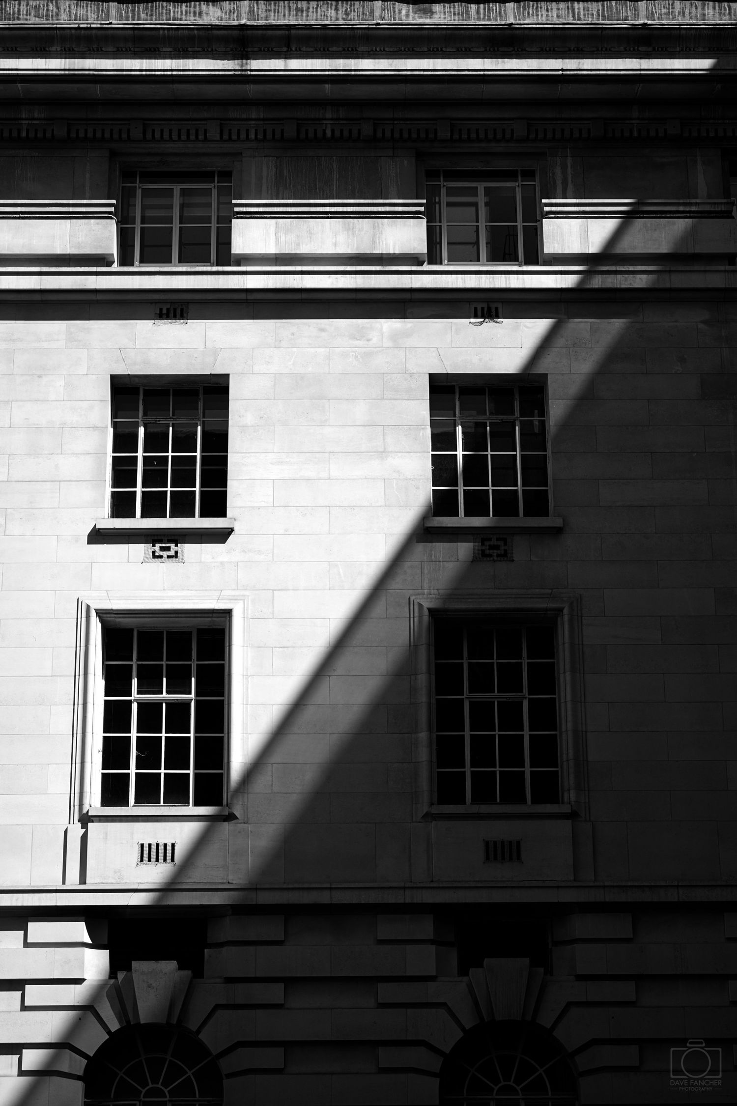 Shadows slice the front of the Marriott hotel in this black and white image