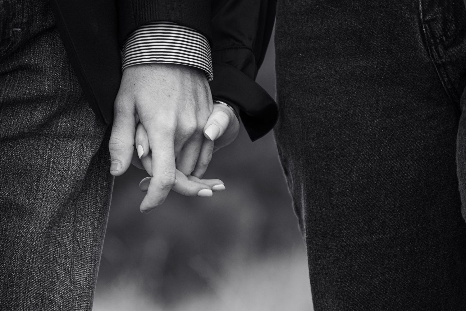 Black and white series showing close-up details of hands and rings in romantic wedding moments.