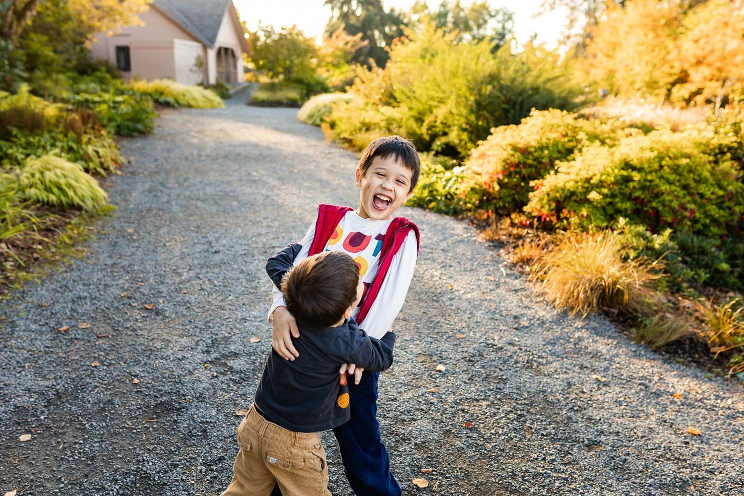 Candid photo captured by photographer of little brother hugging older brother in bellevue