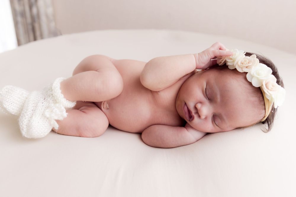 sleeping baby with booties and flower headband
