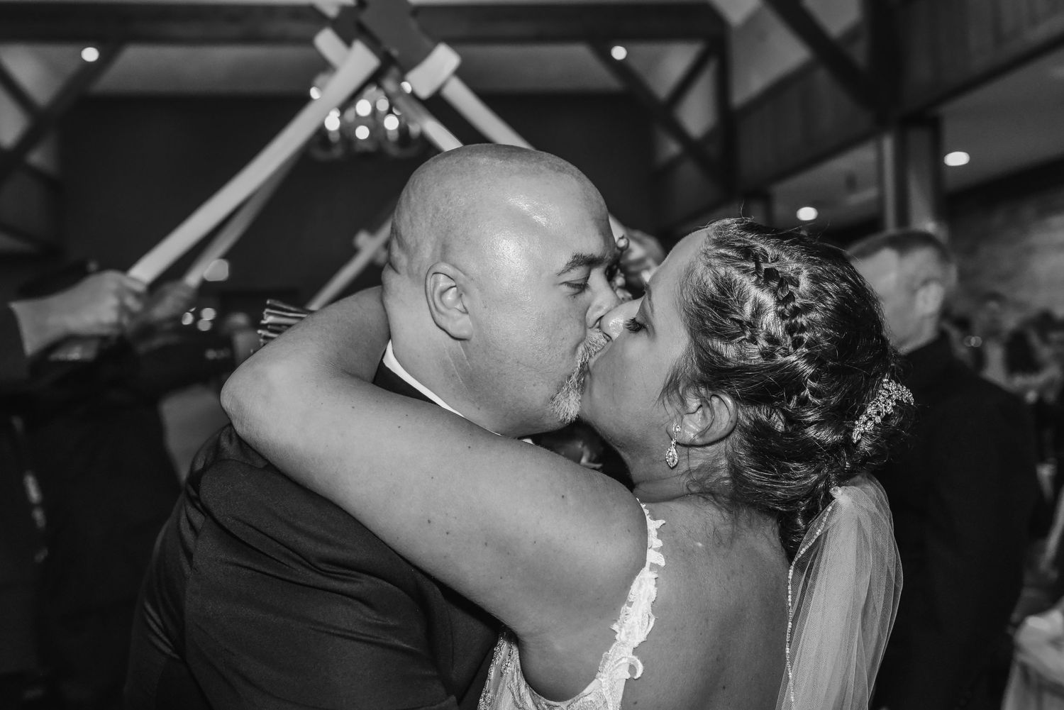 Low-light romantic wedding reception moments captured in black and white.