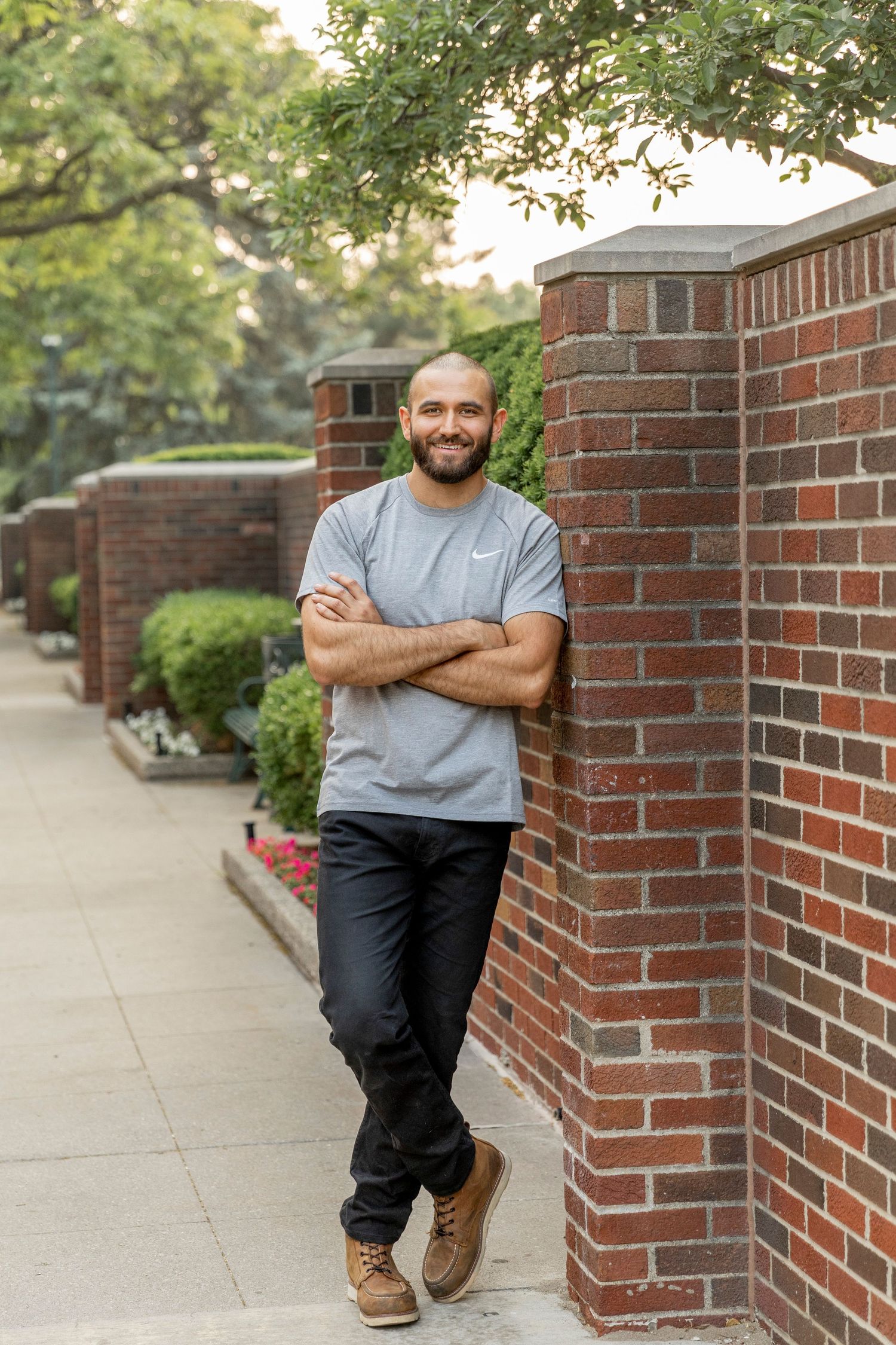 man leaning against a brick wall at Birmingham city hall in Michigan