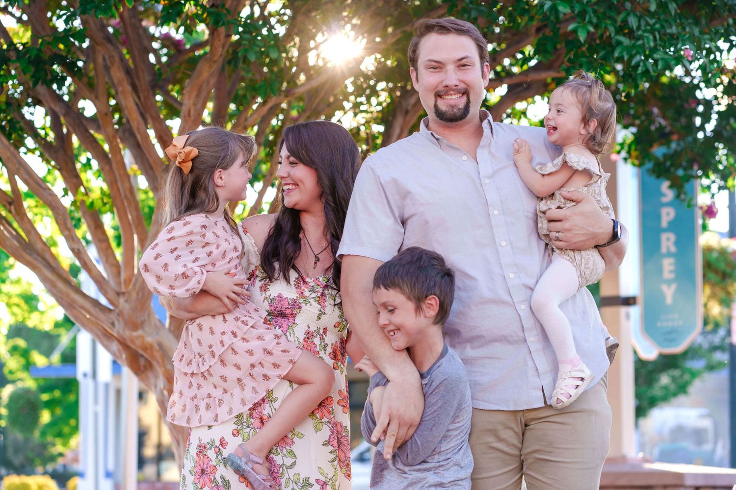 Family of 5 laughing together downtown