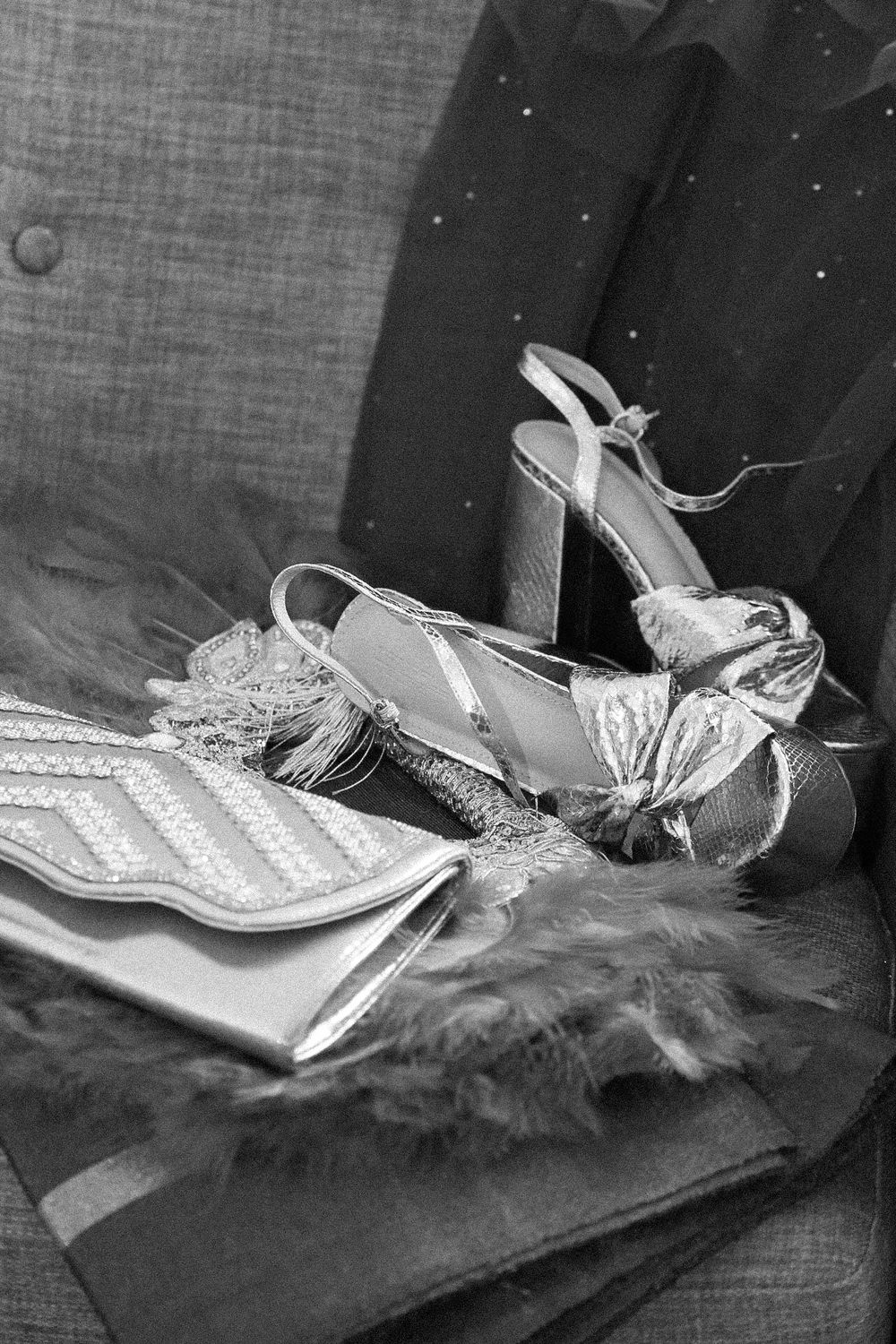 Vintage style bridal shoes with pearl details arranged artistically in black and white.