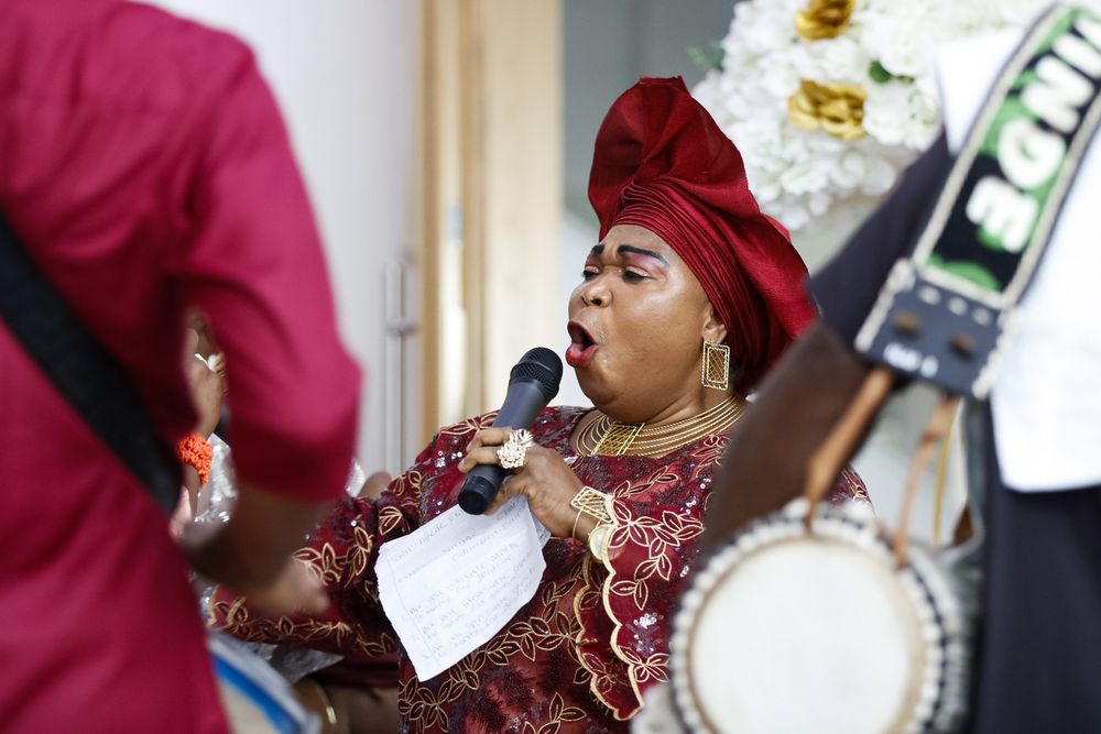 Wedding celebration with festive decor and traditional attire in burgundy colors.