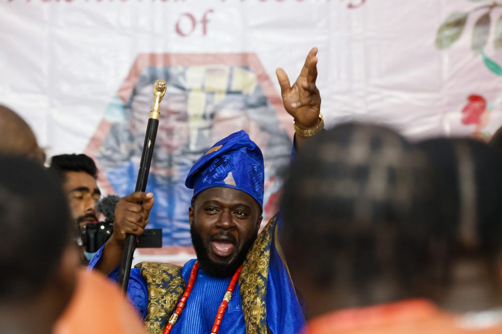 A group of people in colorful traditional dress celebrate at a cultural event.