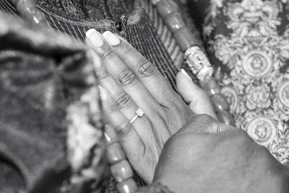 Close-up of hands with rings during a traditional ceremony.