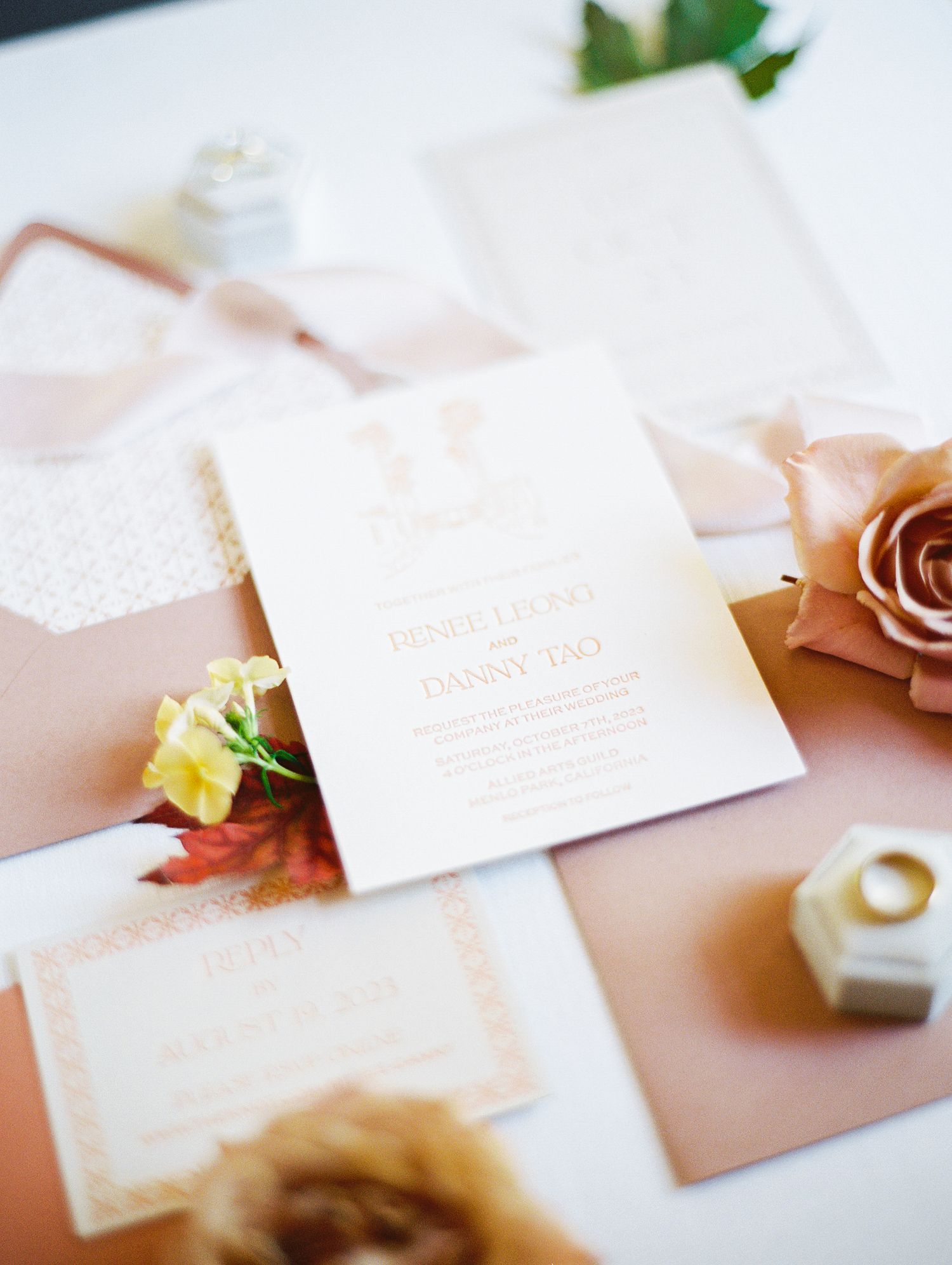 Wedding stationery flat lay featuring blush envelopes; wedding invitation ideas; wedding flat-lay photo ideas; wedding details;
