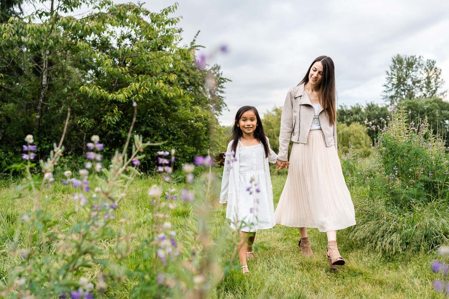 Kirkland family photographer capturing mother daughter holding hands and walking