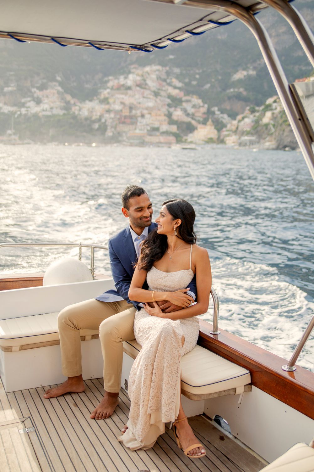 Photo shoot of a surprise proposal on a boat against Amalfi Coast  and Positano background.