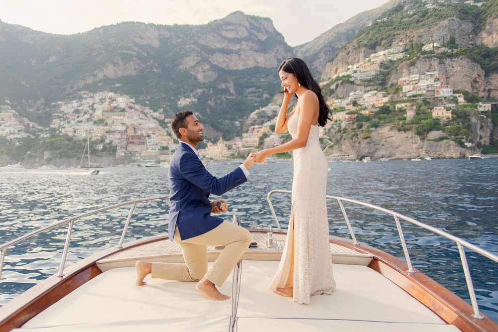 Photo shoot of a surprise proposal on a boat against Amalfi Coast  and Positano background.