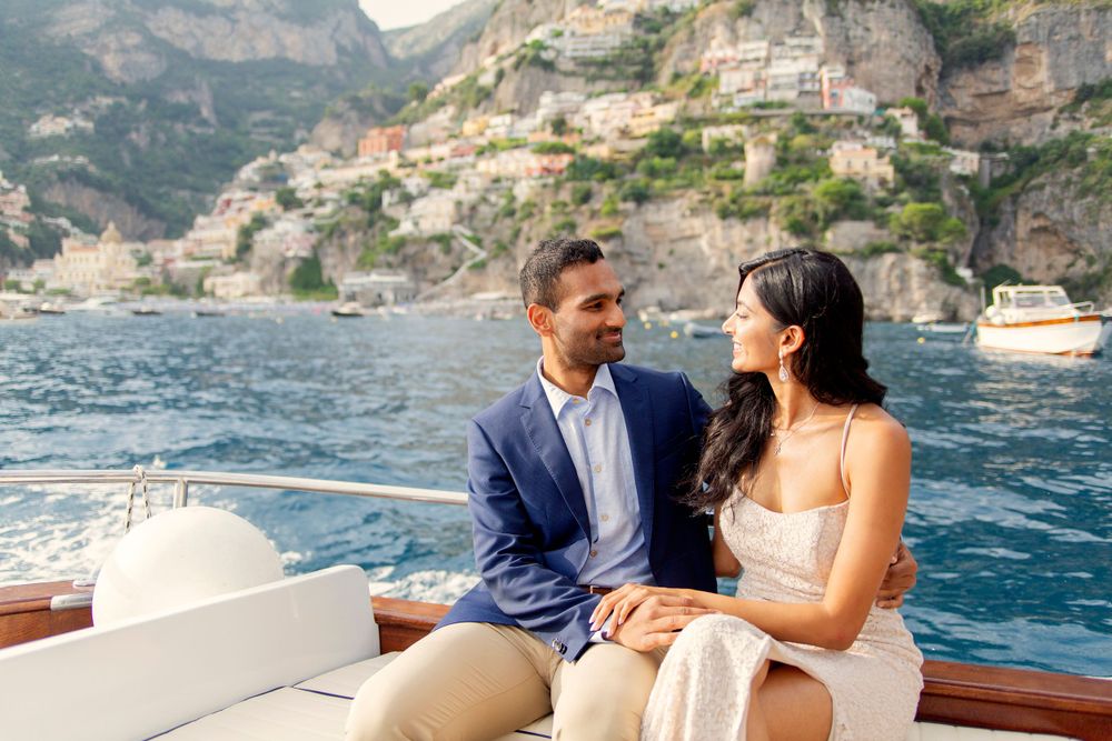 Photo shoot of a surprise proposal on a boat against Amalfi Coast  and Positano background.