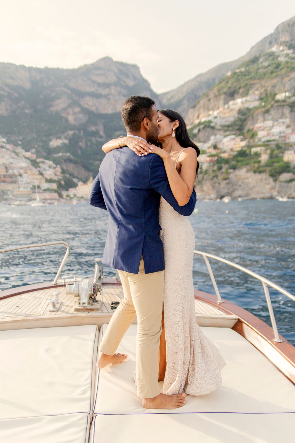 Photo shoot of a surprise proposal on a boat against Amalfi Coast  and Positano background.