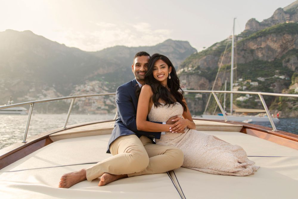 Photo shoot of a surprise proposal on a boat against Amalfi Coast  and Positano background.