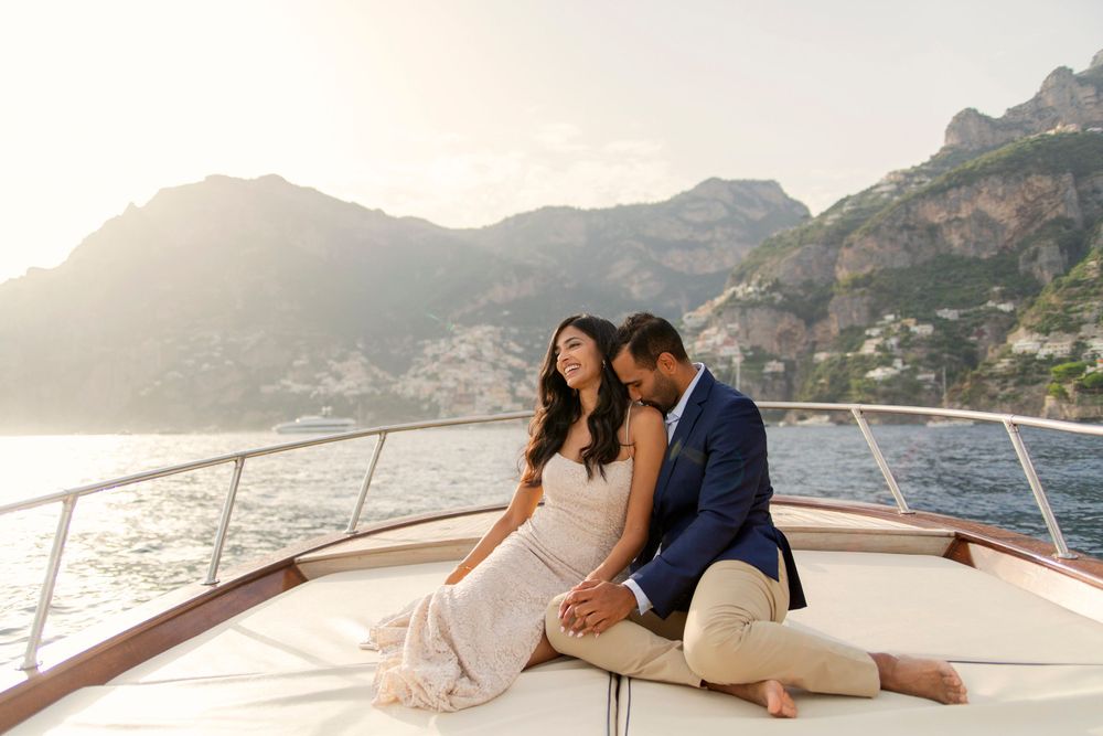 Photo shoot of a surprise proposal on a boat against Amalfi Coast  and Positano background.