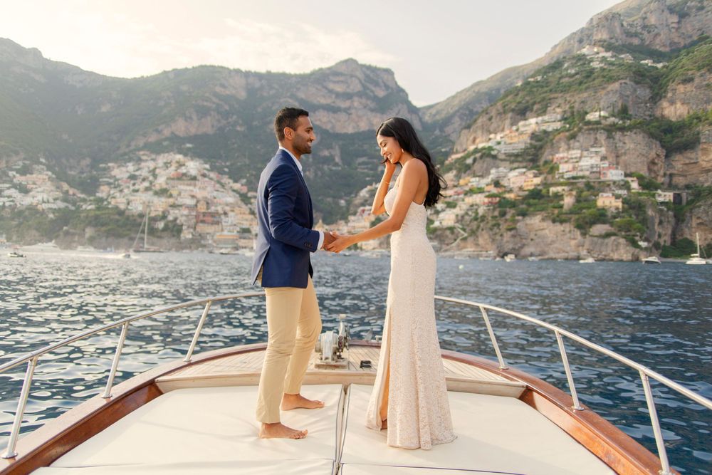 Photo shoot of a surprise proposal on a boat against Amalfi Coast  and Positano background.