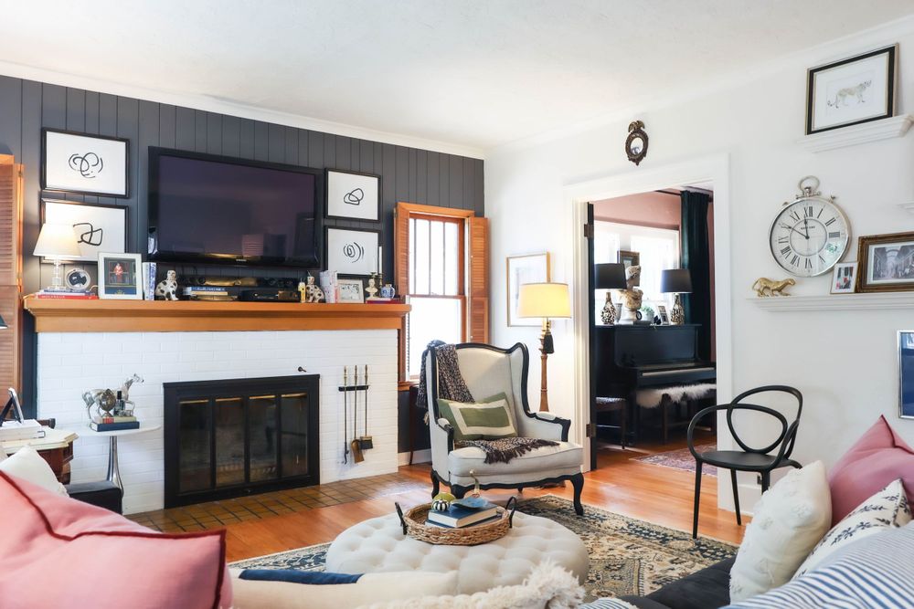 Contemporary living room featuring white walls, hardwood floors and modern entertainment setup.