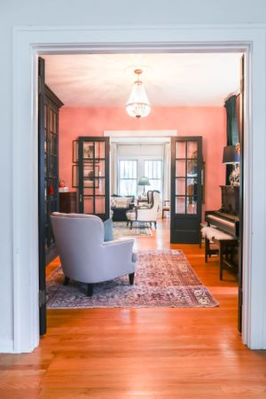 Bright open-concept living space with hardwood floors and white trim details.