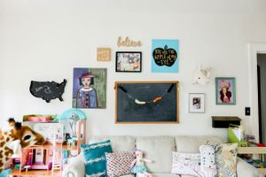 Bright white room with decorative wall art and organized storage shelves.