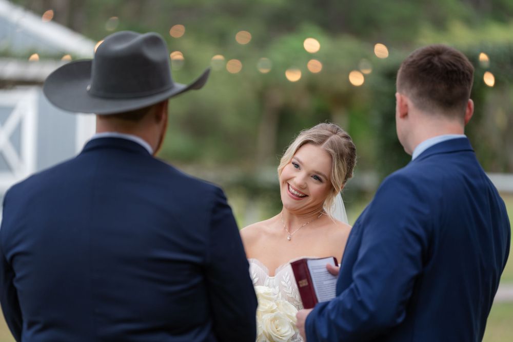 Candid moment of laughter during outdoor wedding ceremony.
