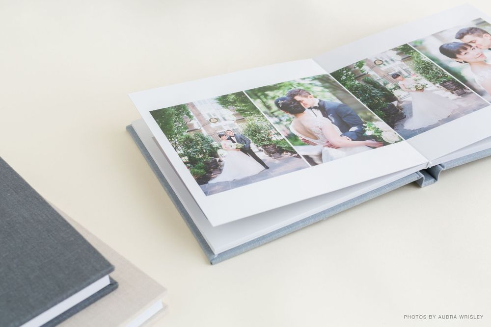 Wedding photo book lying open to display multiple wedding day photographs.