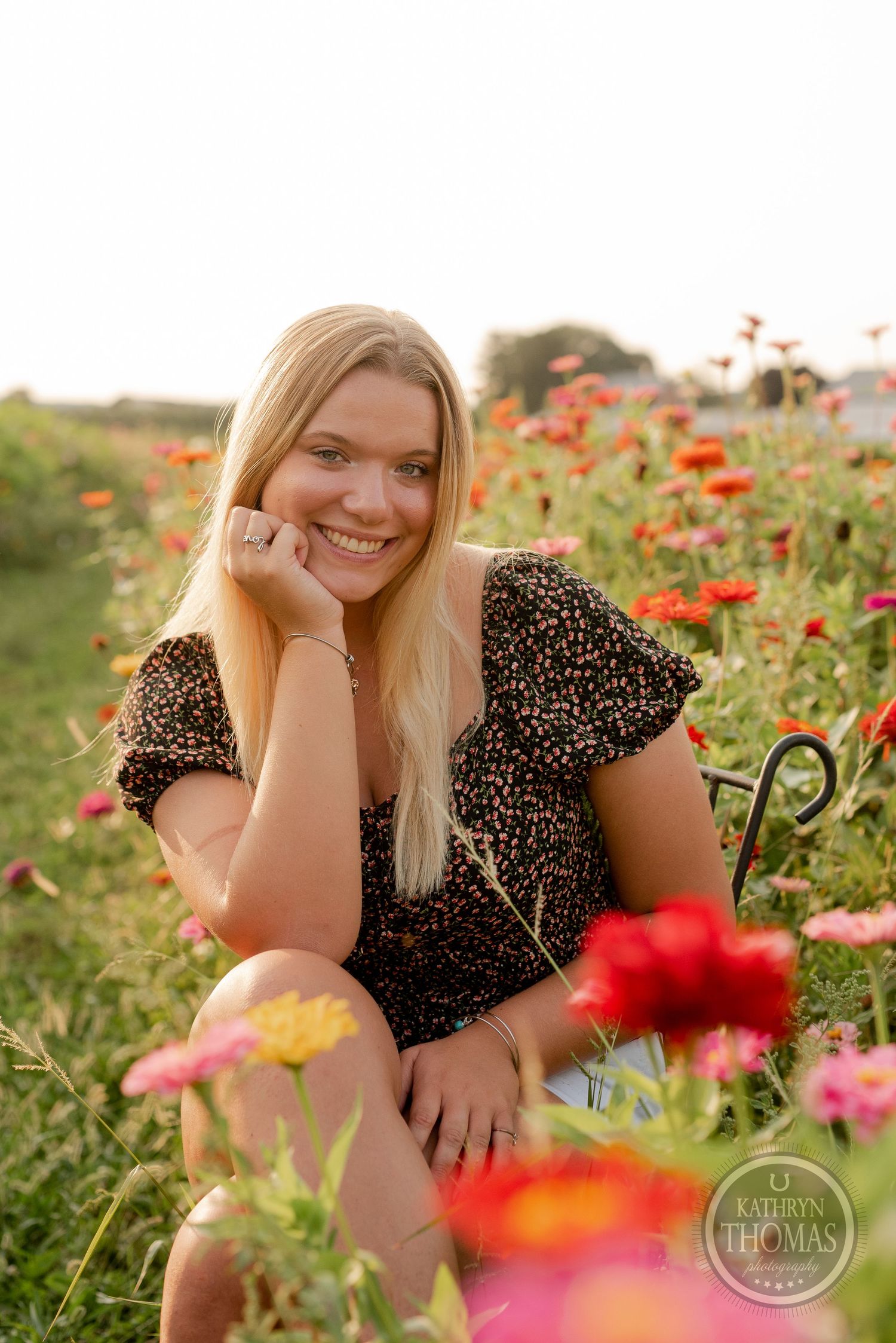 A cheerful portrait among red poppies and wildflowers during golden hour.