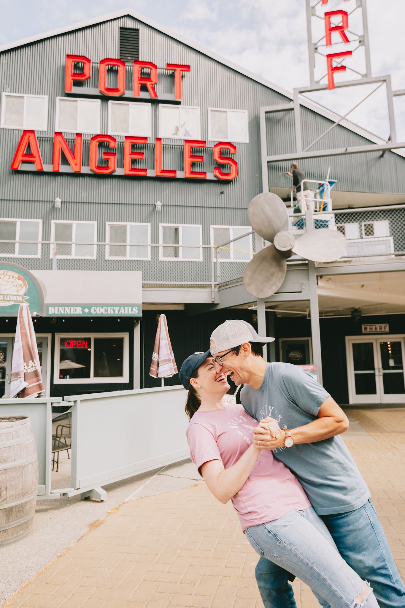 Man dips Woman infront of building that say Port Angeles in big red letters