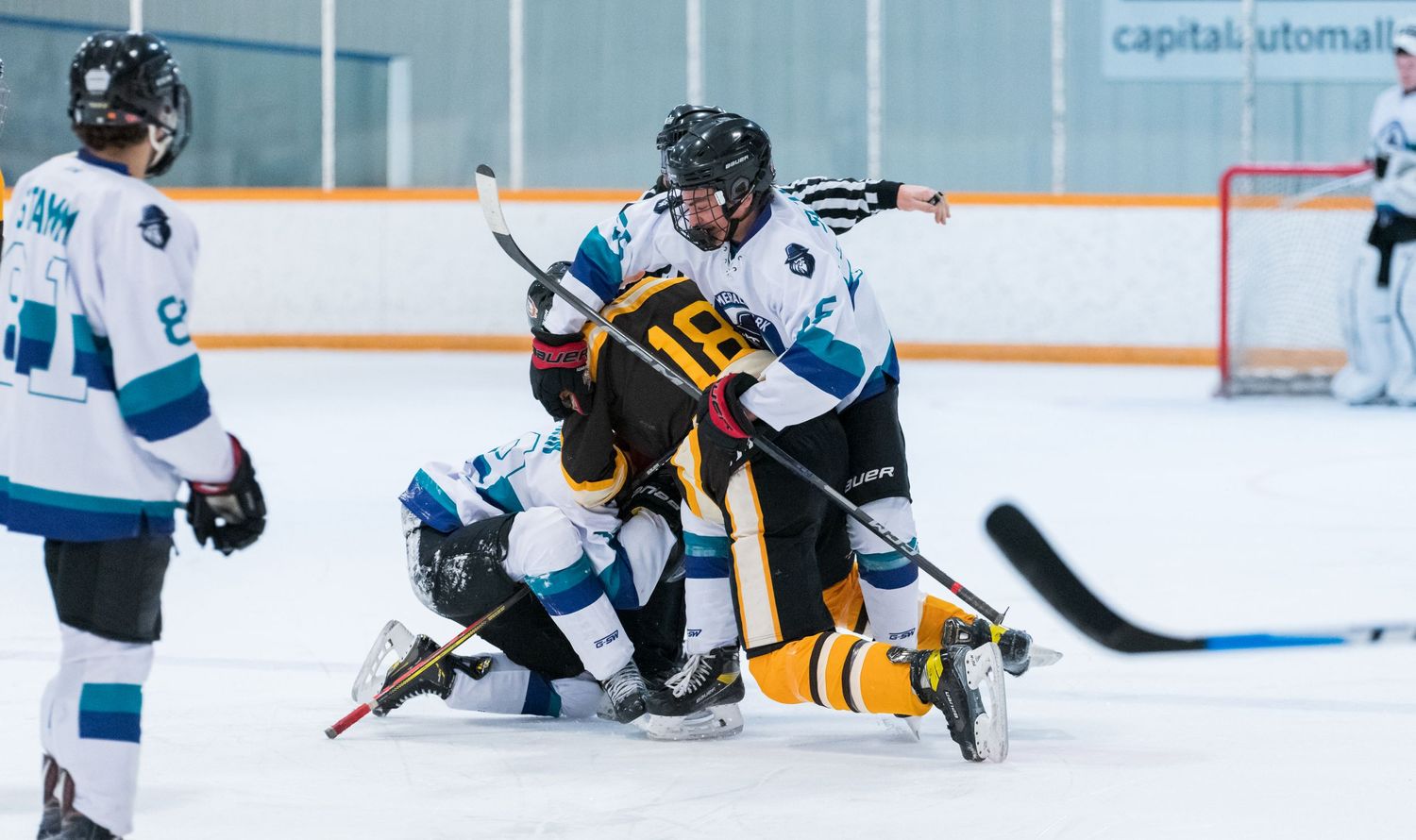 Two hockey players collide on the ice during an intense game moment.