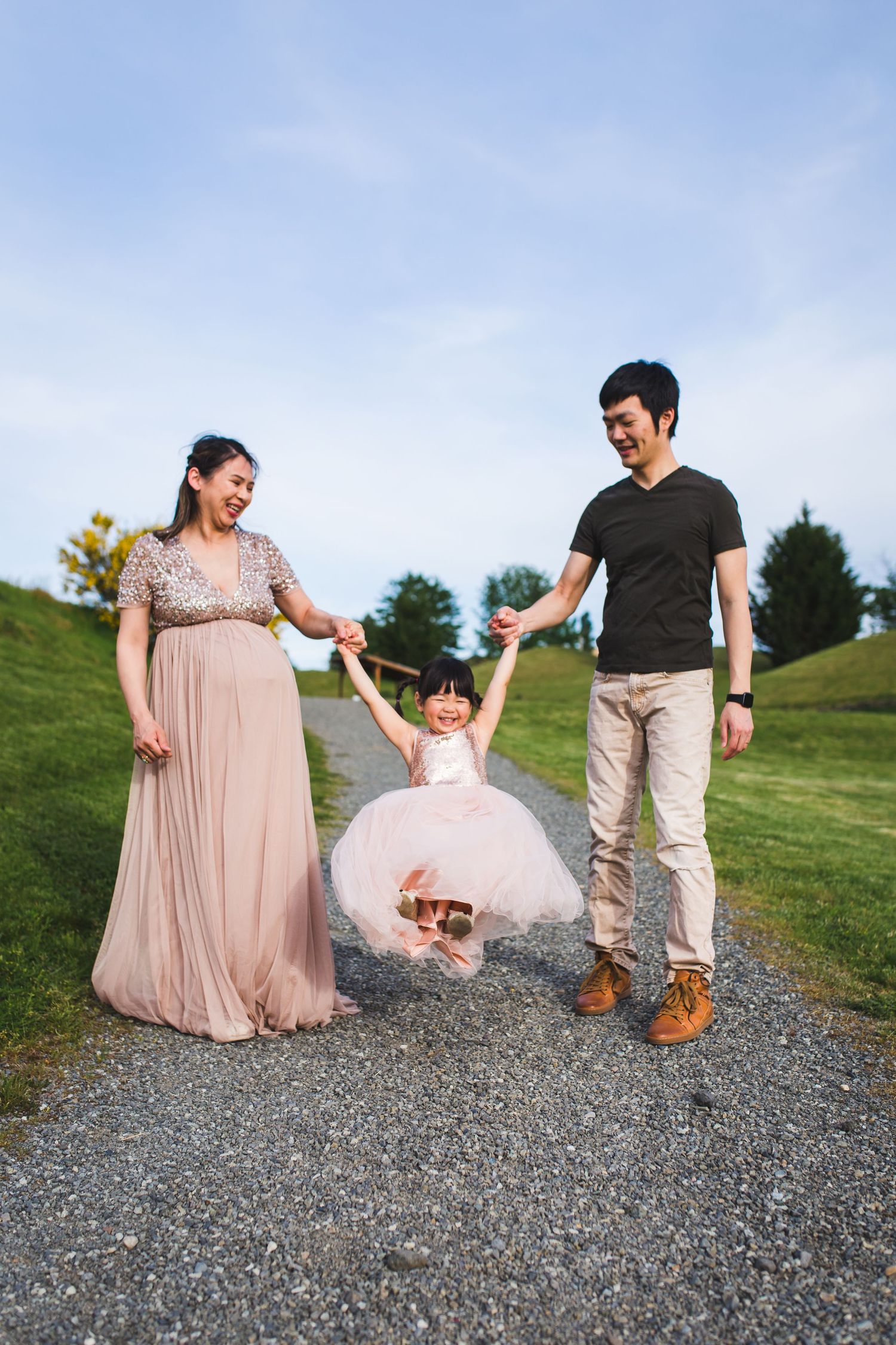Best Redmond Family and Maternity photographer, parents swinging daughter, candid, lifestyle, golden hour