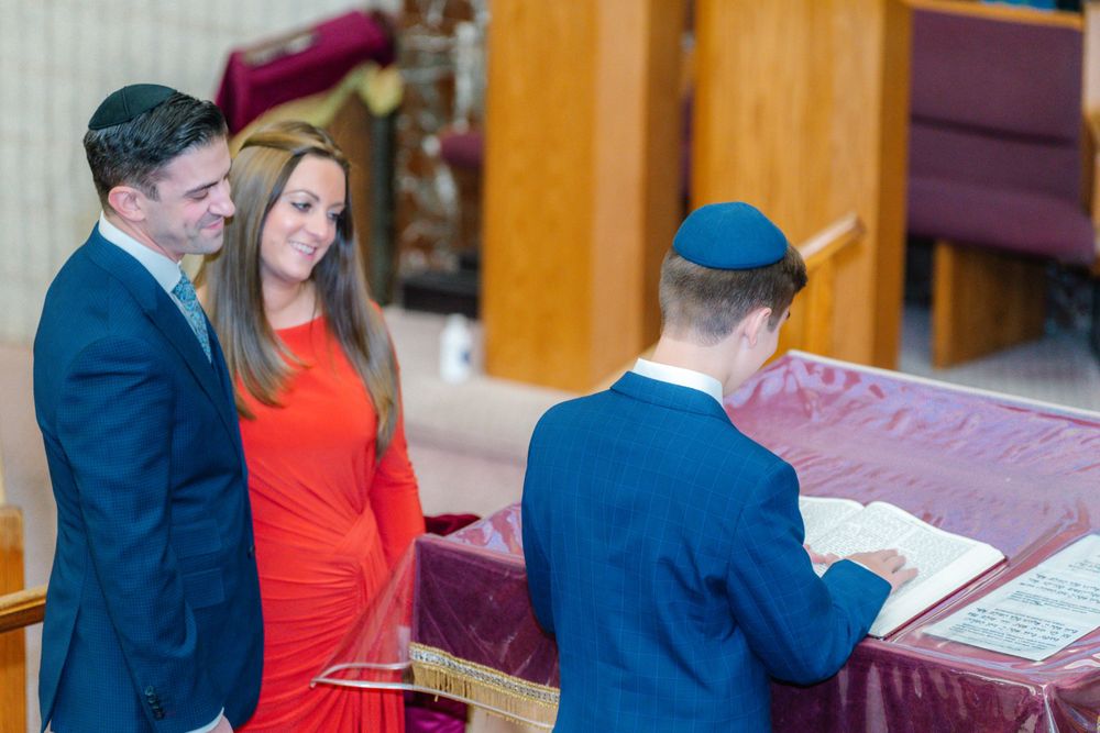 Religious ceremony scene with formal attire and traditional setting.