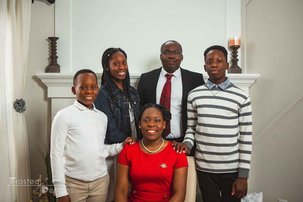 Family of 5 at home in front of their fireplace for a family photography session.