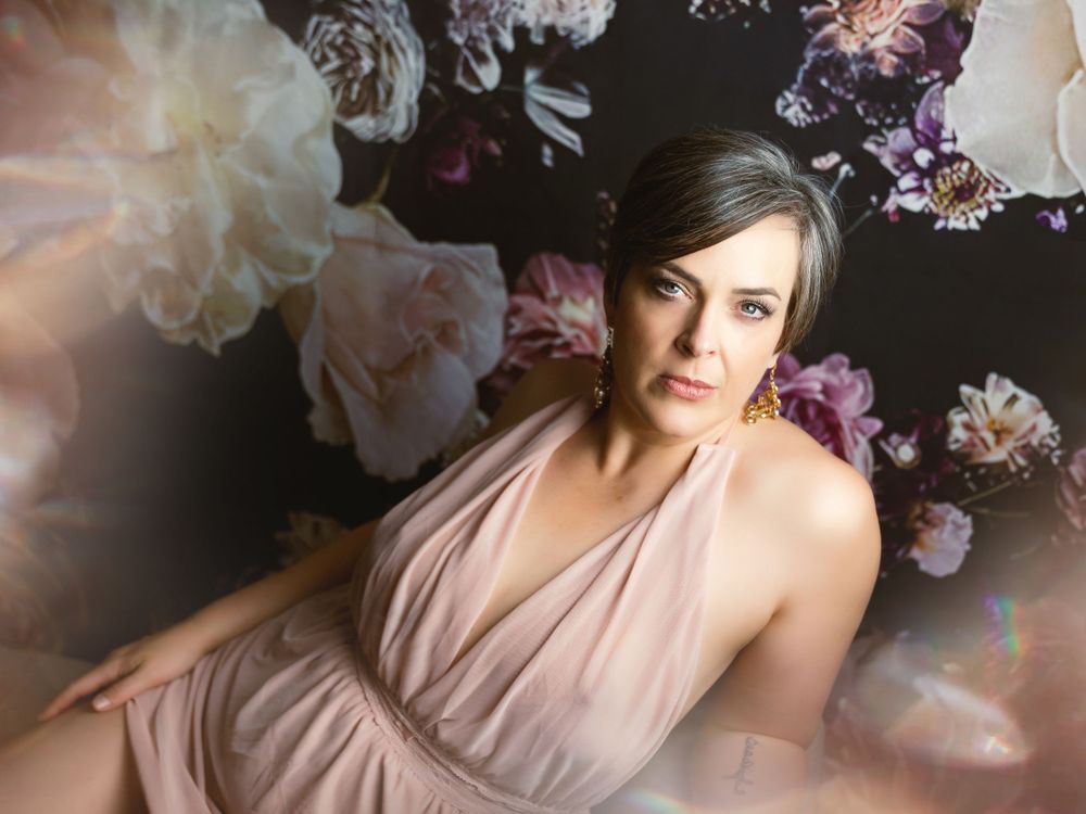 Very beautiful boudoir image with a floral backdrop and a lady in pretty light pink lingerie. Greenville, SC boudoir photographer— Easley SC