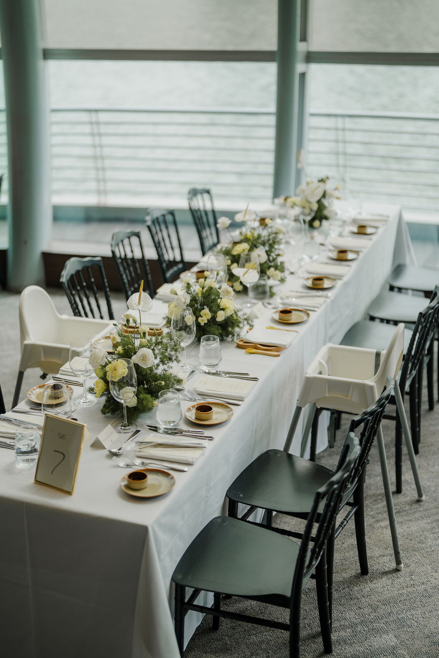 Elegant wedding reception tables set with white linens and floral centerpieces.