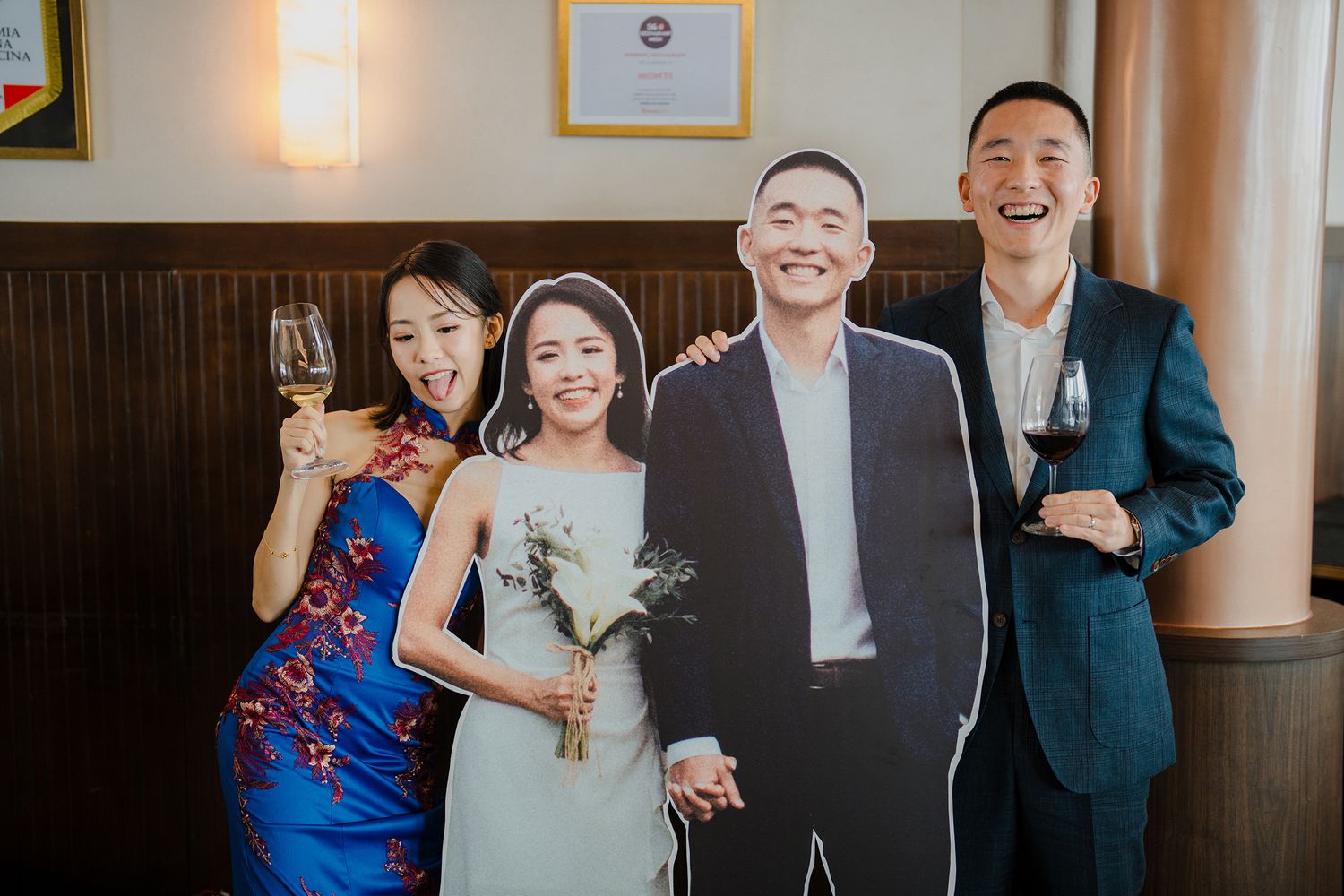 Wedding celebration in an elegant venue with decorative wood paneling and formal attire.