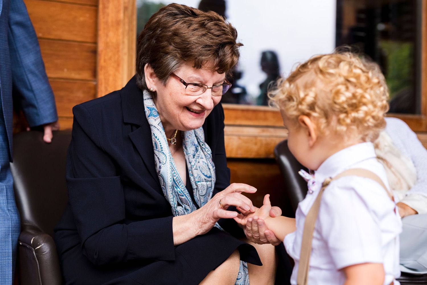 Two people sharing an intimate conversation during a special occasion indoors.