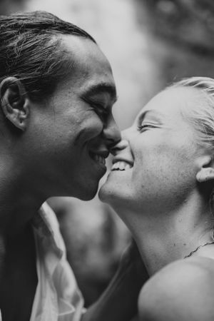 Close-up black and white photo of a couple sharing an intimate moment.