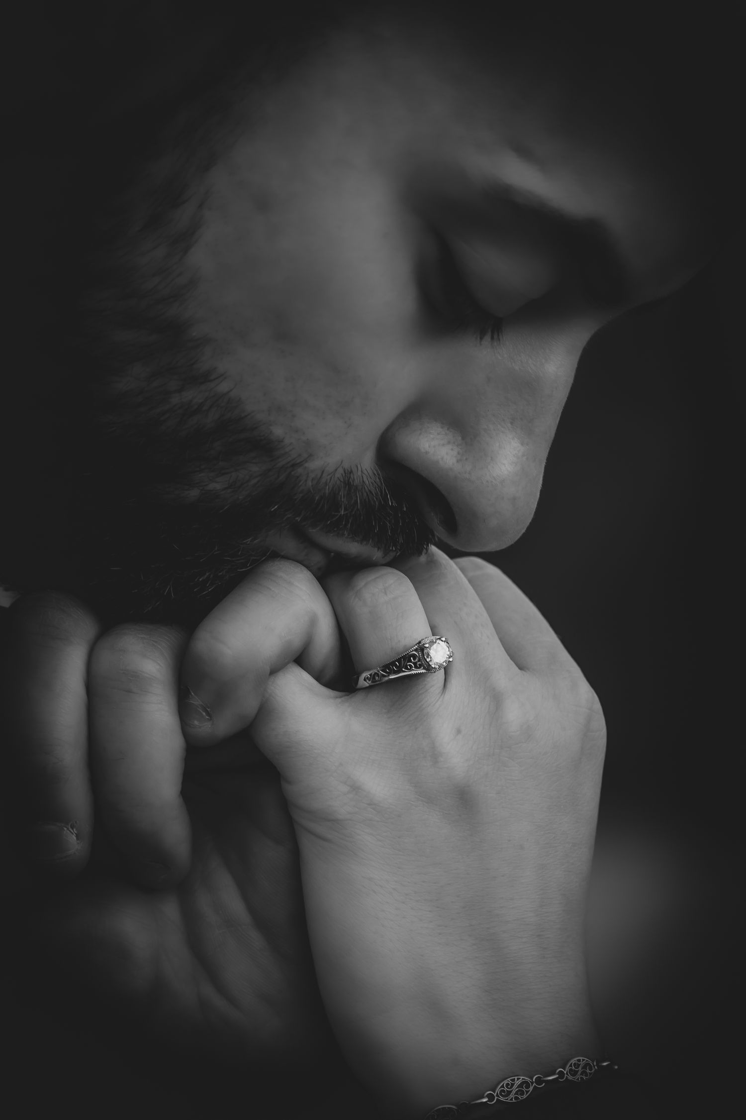 a man gives a pink promise to his fiance. He kisses the ring romantically.