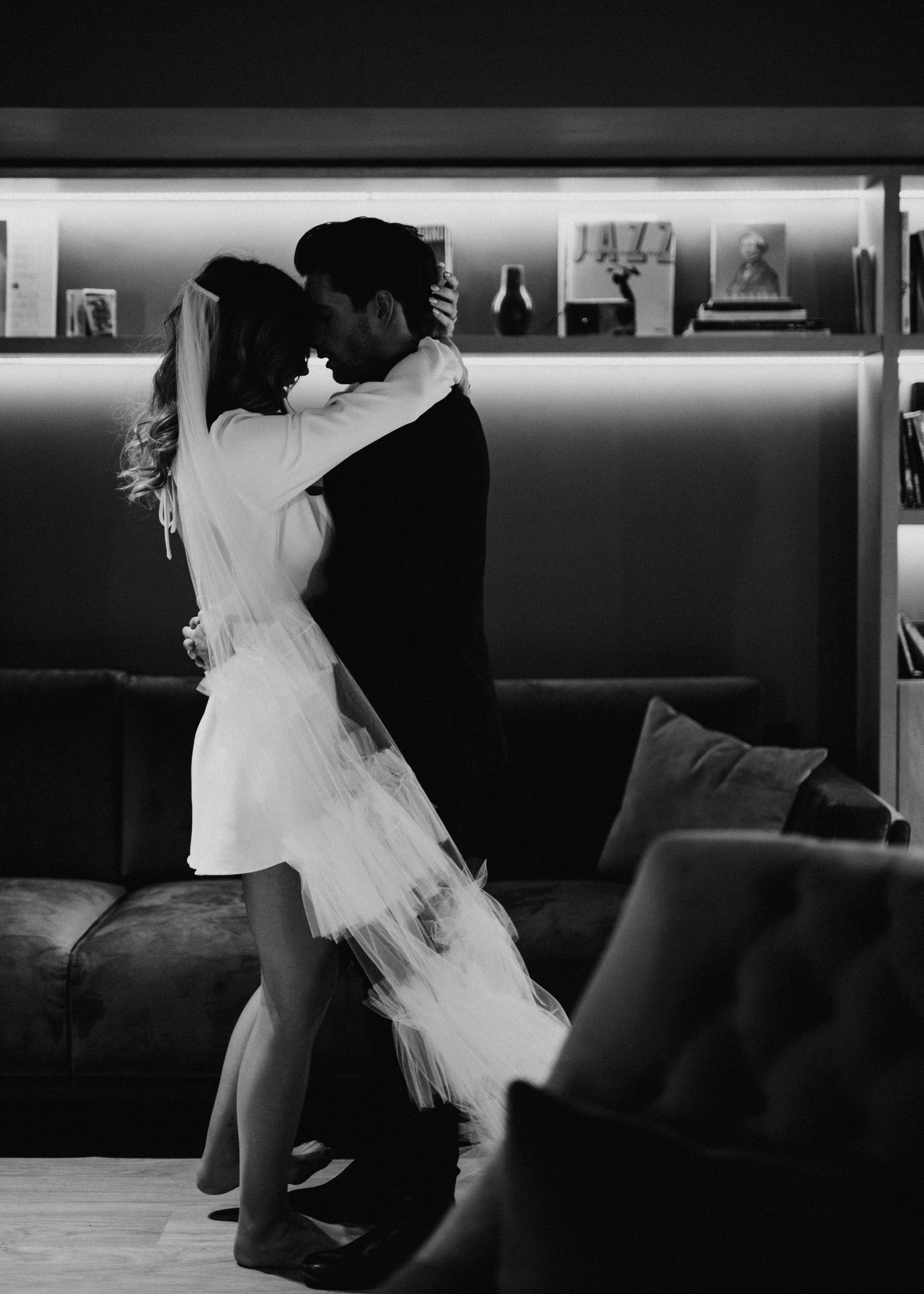Black and white wedding sequence showing intimate moments in modern interior.