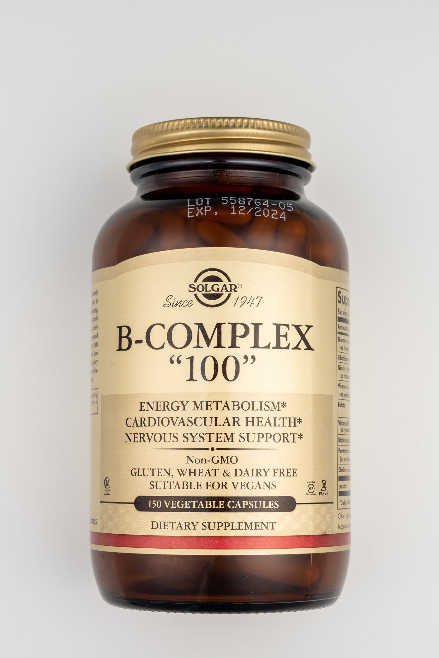 Bottle of Solgar B-Complex 100 vitamin supplement with gold cap on white background.