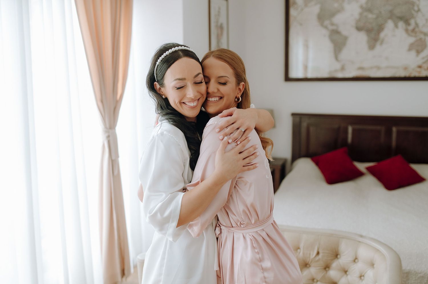 Candid moment of friendship and joy during wedding morning preparations.