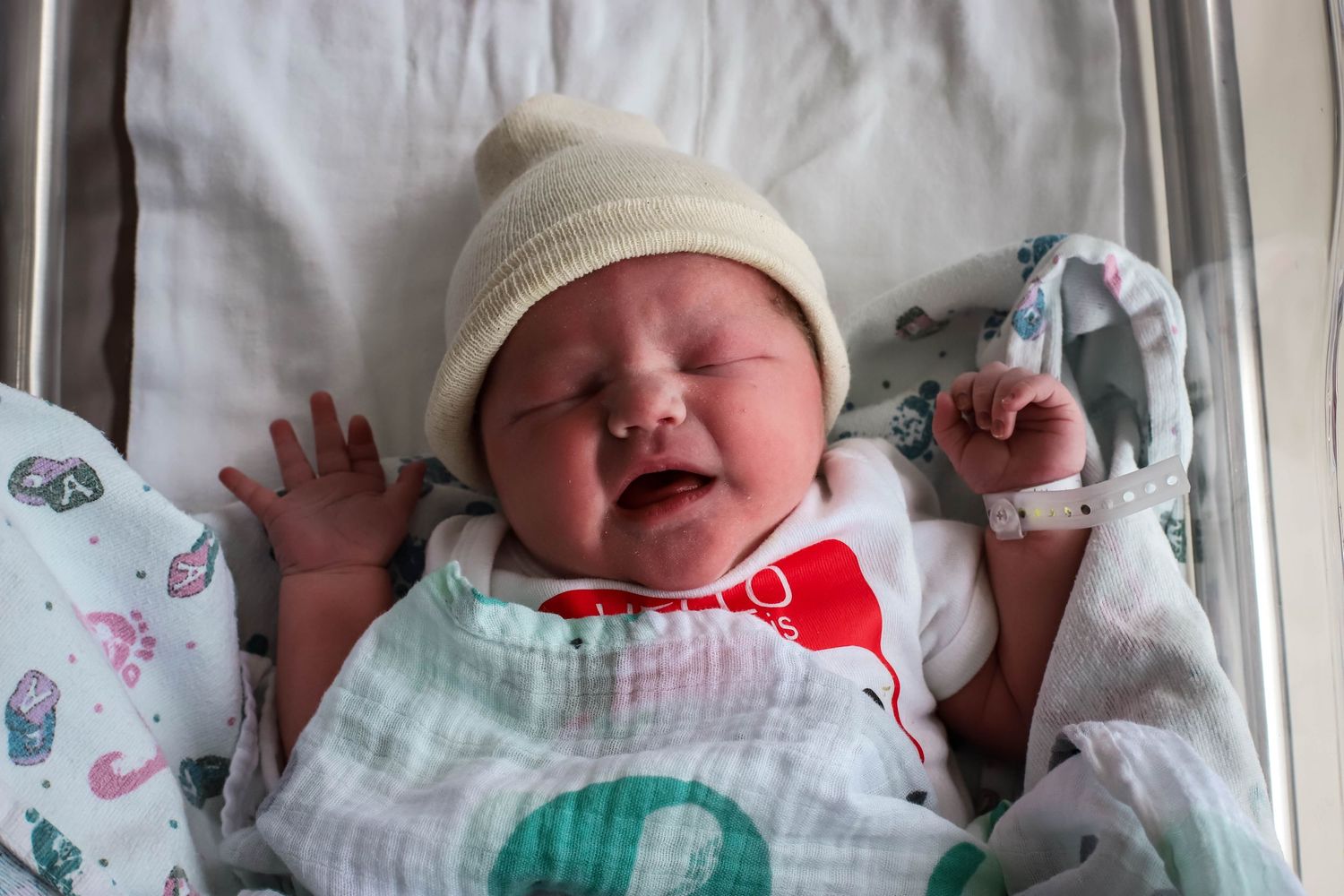 Newborn baby boy in his hospital bassinet a day after birth during his fresh 48 session in Sioux City, IA.