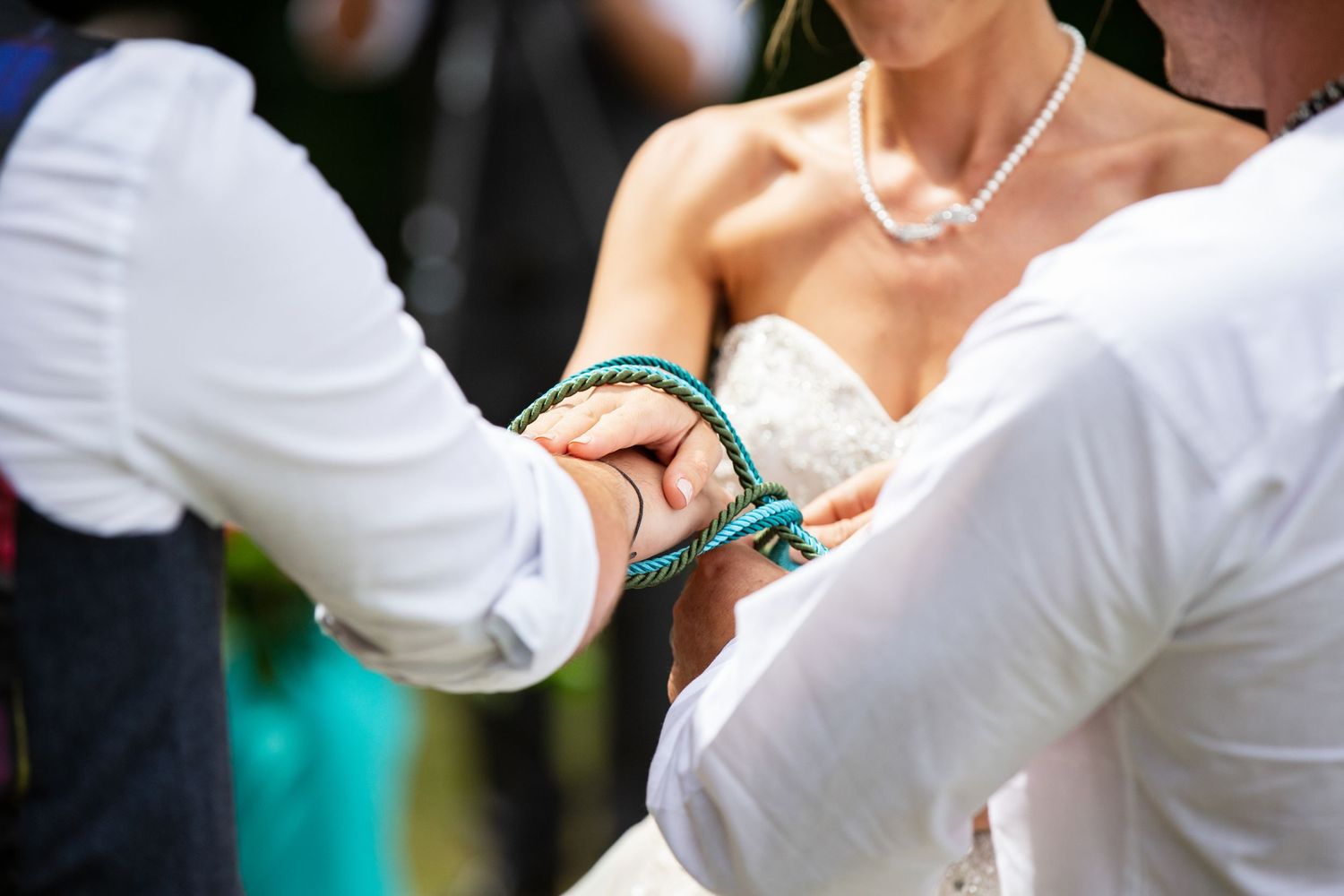 Wedding party members in white dresses adjusting their formal attire.