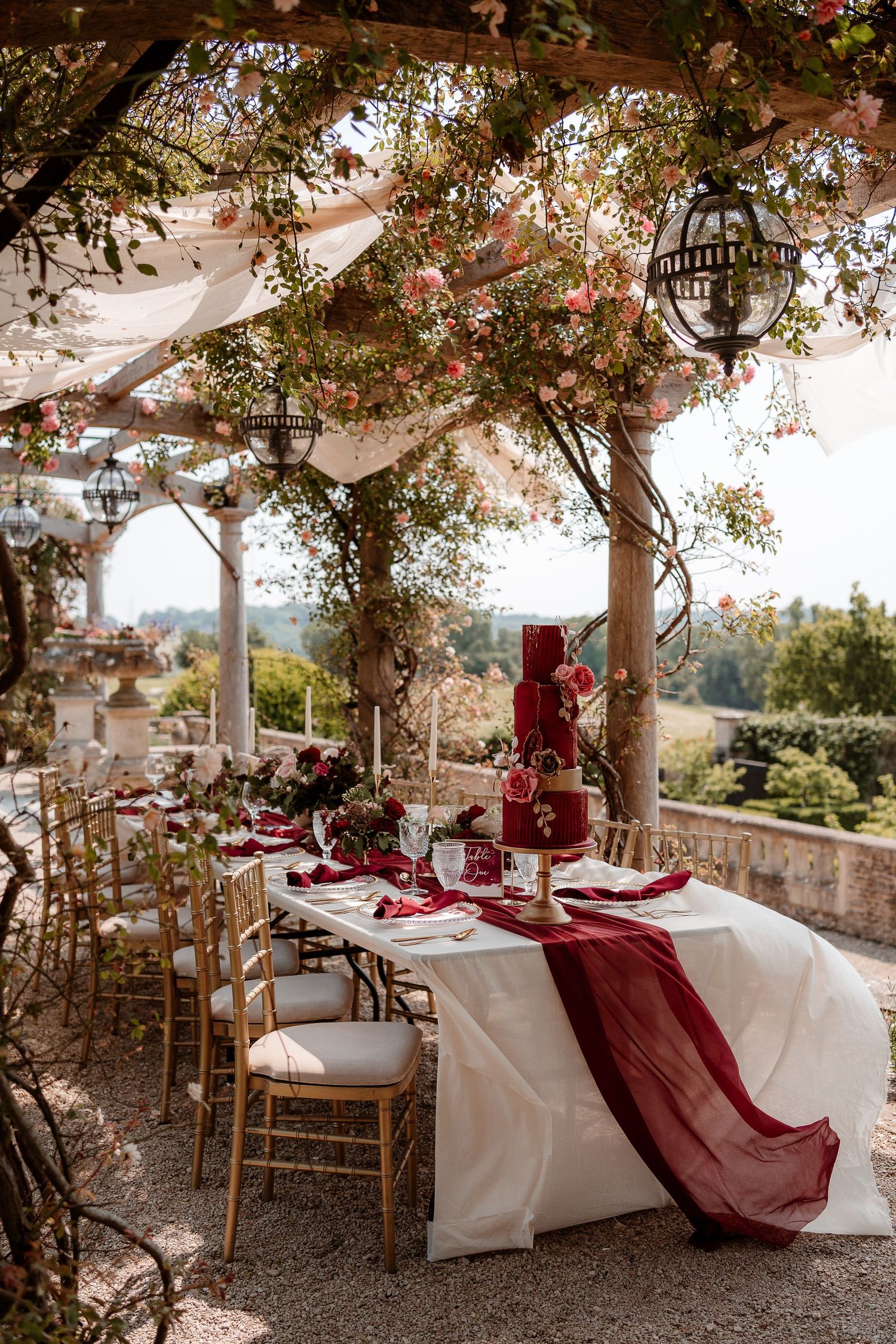 An al fresco wedding table set up under the pergola at Euridge Manor, luxury Cotswolds wedding venue