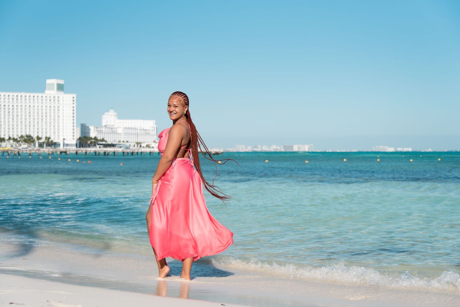 DeJean posing in her elegant Sweet-Sixteen dress on the beach at the Hyatt Ziva resort in Cancun