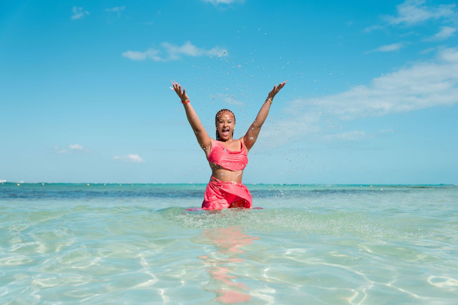 DeJean splashing in the crystal-clear water, creating a fun and joyful moment during the session