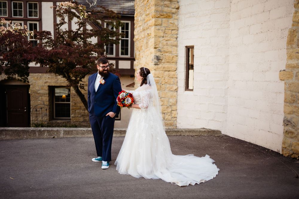 Stone and white building exterior creates elegant backdrop for wedding photography.