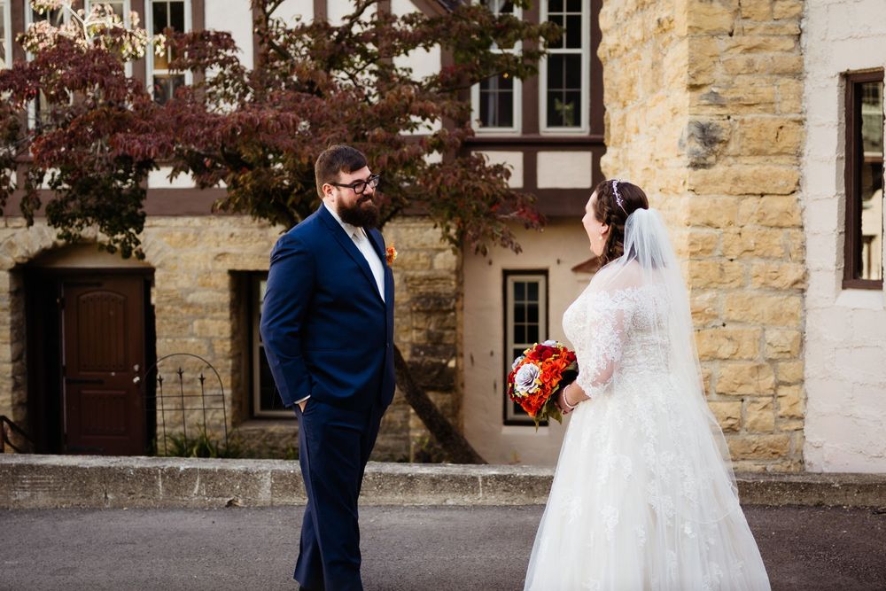 Romantic stone building facade creates perfect backdrop for wedding photography.