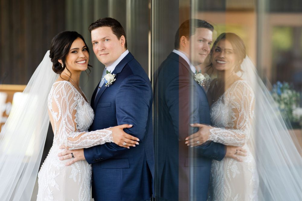 Bride and groom portrait with window reflection during wedding day at Jorgensen Farms in Westerville, Ohio.