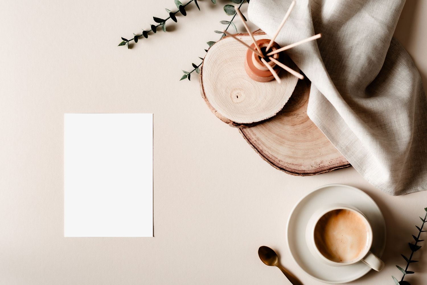 Coffee and reed diffuser flatlay with wood accents, blanket and gold spoon. Stylish, relaxing, interiors